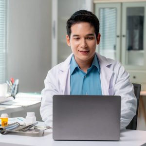 asian-doctor-using-laptop-providing-online-healthcare-services-in-modern-clinic.jpg