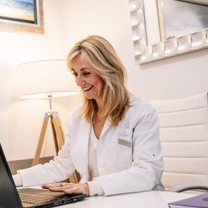 cheerful-doctor-using-laptop-in-office.jpg