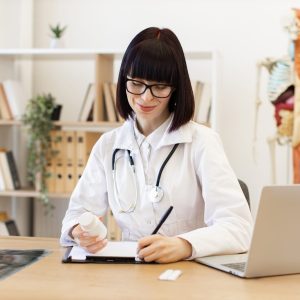 female-doctor-writing-prescription-in-medical-office.jpg