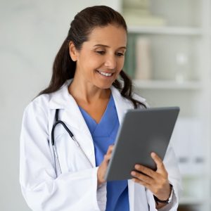 happy-middle-aged-lady-doctor-working-on-digital-tablet.jpg